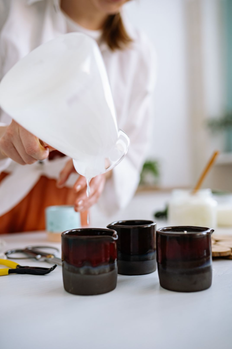 Pouring candles at a kitchen counter
